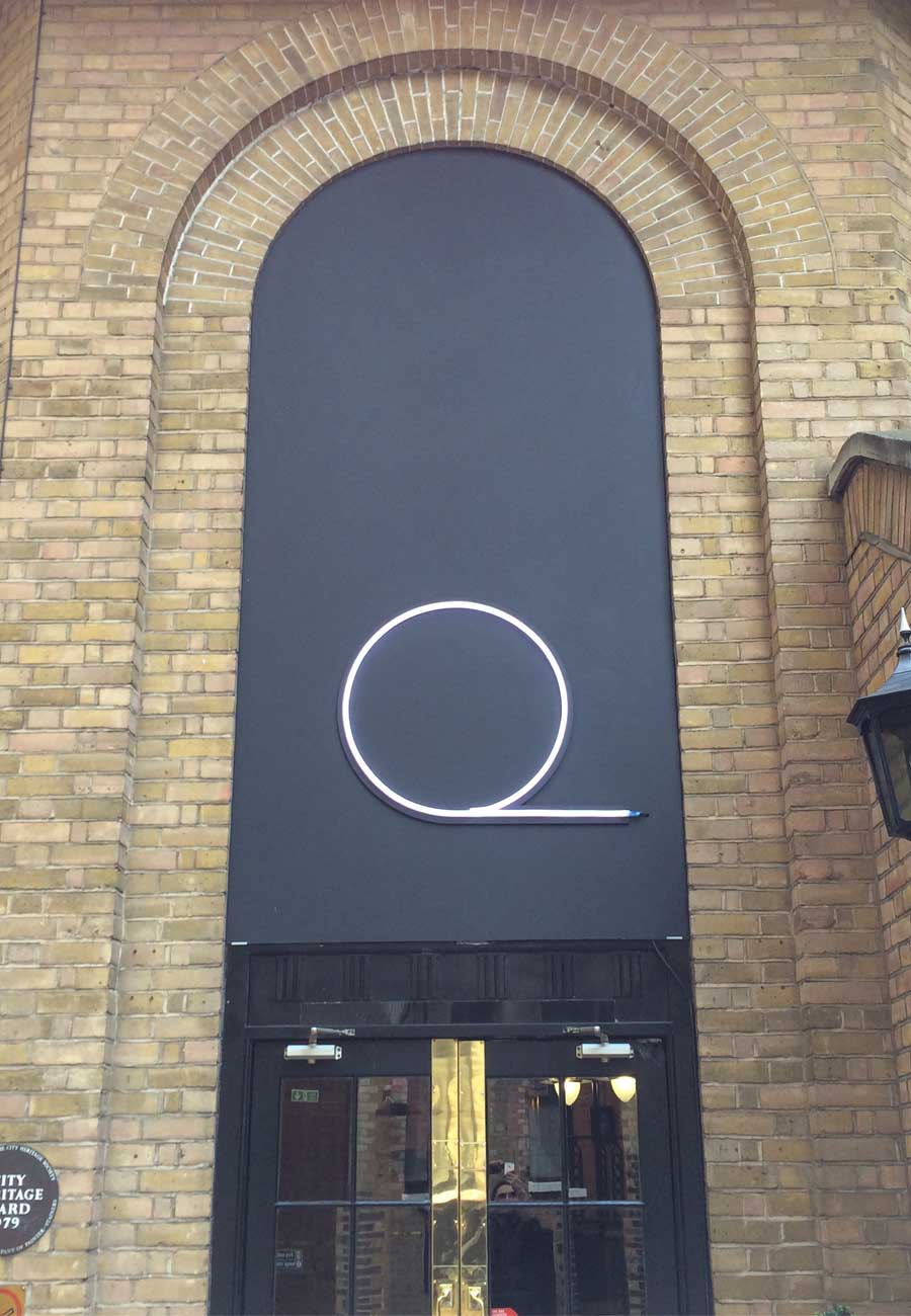 Quantcast LED Neon Sign Quantcast logo in LED neon sign over a doorway